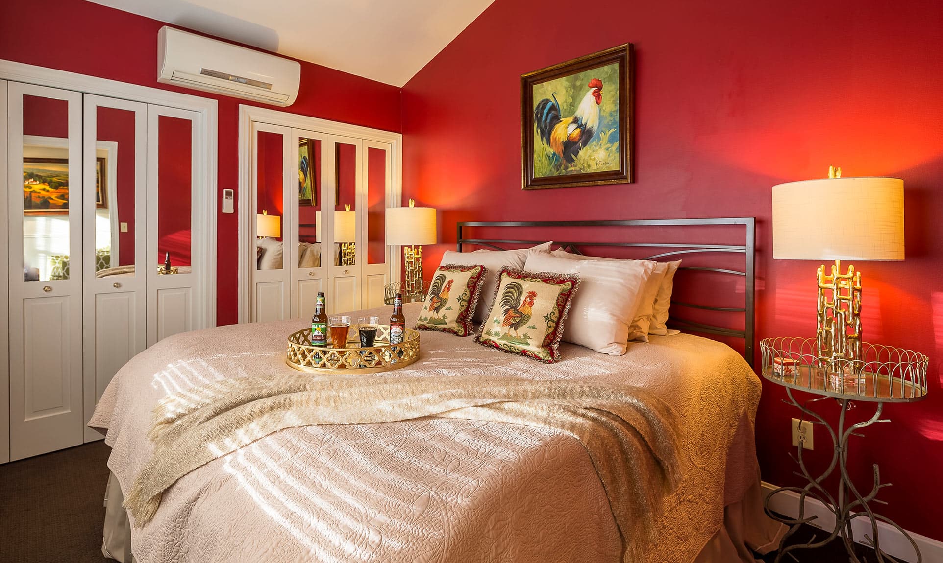 King Bed in Cottage Suite with Red Walls and Rooster Painting